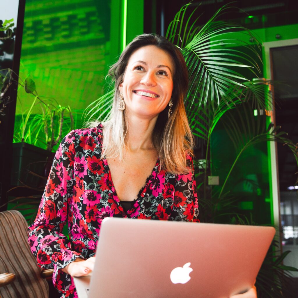 happy woman sitting with her laptop