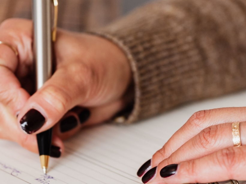 Woman writing in her planner